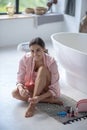 Smiling young woman painting her nails at home Royalty Free Stock Photo