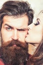 Beauty salon and barber shop. Sensual woman kiss bearded man, love. Woman with makeup skin and hipster with long beard