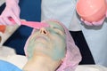 Beautician applies Alginate Peel-Off Powder Mask for the face