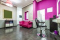 Beauty salon with chesterfield sofa upholstered in pink velvet fabric