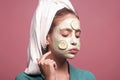 Beauty salon concept. Young woman skincare. Woman face with cucumber mask on violet background. Girl morning. Royalty Free Stock Photo