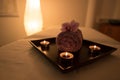 Beauty salon decoration in massage room, candles, towel and orchid