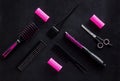 Hairdresser equipment for cutting hair and styling with combs, sciccors, brushes on black background top view pattern Royalty Free Stock Photo