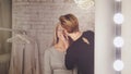 Beauty salon - makeup artist and blonde model near mirror in the dressing room Royalty Free Stock Photo