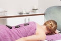 Beauty salon. Woman getting spa hot stone therapy massage Royalty Free Stock Photo