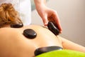 Beauty salon. Woman getting spa hot stone therapy massage Royalty Free Stock Photo