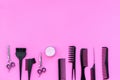 Beauty saloon equipment. Hairdress, haircut. Combs, sciccors, brushes on pink background top view copy space