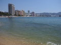 Beauty sandy beach at bay of ACAPULCO city in Mexico with luxury hotels buildings and calm Pacific Ocean