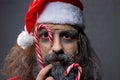 Beauty santa with christmas lollipops. close-up portrait christmas concept