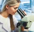 Beauty scientist Looks in microscope in chemical laboratory