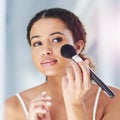 Beauty, self care and woman with a makeup brush for a natural, skin and face in her bathroom. Cosmetic, glamour and