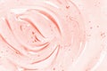 Beauty serum gel texture. Pink clear skincare cream with bubbles background