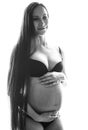 Beauty brunette pregnant woman isolated black and white por Royalty Free Stock Photo