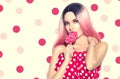 Beauty sexy model woman with pink hairstyle and beautiful makeup holding lollipop candy Royalty Free Stock Photo