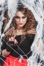 Beauty Witch girl caught in a spider web. Fashion Art design. Beautiful Gothic model girl with Halloween make up Royalty Free Stock Photo