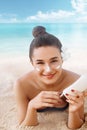 Beauty Sexy Young Woman in Bikini Holding Bottles of Sunscreen in Her Hands. Skin care. Beautiful Female Applying Sun Royalty Free Stock Photo