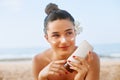 Beauty Sexy Young Woman in Bikini Holding Bottles of Sunscreen in Her Hands. Skin care. A Beautiful Female Applying Sun Cream. Royalty Free Stock Photo