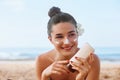 Beauty Sexy Young Woman in Bikini Holding Bottles of Sunscreen in Her Hands. Skincare. Royalty Free Stock Photo