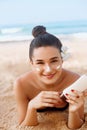 Beauty Sexy Young Woman in Bikini Holding Bottles of Sunscreen in Her Hands. Skincare Royalty Free Stock Photo