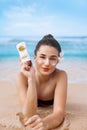 Beauty Sexy Young Woman in Bikini Holding Bottles of Sunscreen in Her Hands. Skincare. A Beautiful Female Applying Sun Royalty Free Stock Photo