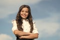 Beauty shines. Happy child smile with confidence on sunny sky. Little girl wear long wavy hairstyle. Beauty and hair