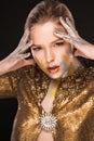 Beauty shoot of luxurious blonde lady with gold and silver paint Royalty Free Stock Photo