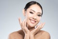 Beauty shot of young pretty asian woman with clear skin ongrey b Royalty Free Stock Photo