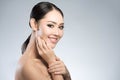 Beauty shot of young pretty asian woman with clear skin ongrey b