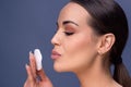 Beauty skin care. Beautiful happy woman removing face makeup using cotton pad. Close up portrait of healthy female model with nat