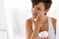 Beauty Skin Care. Beautiful Woman Applying Cosmetic Face Cream Royalty Free Stock Photo