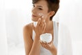 Beauty Skin Care. Beautiful Woman Applying Cosmetic Face Cream Royalty Free Stock Photo