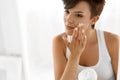 Beauty Skin Care. Beautiful Woman Applying Cosmetic Face Cream Royalty Free Stock Photo