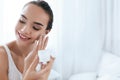 Beauty Skin Care. Beautiful Woman Applying Cream On Face Skin Royalty Free Stock Photo