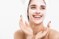 Beauty Skin Care Concept - Beautiful Caucasian Woman Face Portrait applying cream mask on her facial skin white Royalty Free Stock Photo