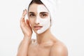 Beauty Skin Care Concept - Beautiful Caucasian Woman Face Portrait applying cream mask on her facial skin white Royalty Free Stock Photo