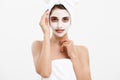 Beauty skin care concept - beautiful caucasian woman face portrait applying cream mask on her facial skin white Royalty Free Stock Photo