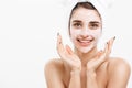 Beauty Skin Care Concept - Beautiful Caucasian Woman Face Portrait applying cream mask on her facial skin white Royalty Free Stock Photo