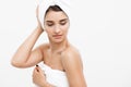 Beauty and Skin care concept - Beautiful caucasian Young Woman with bath towel on head covering her breasts, on white. Royalty Free Stock Photo