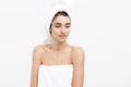 Beauty and Skin care concept - Beautiful caucasian Young Woman with bath towel on head covering her breasts, on white Royalty Free Stock Photo