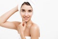 Beauty and Skin care concept - Beautiful caucasian Young Woman with bath towel on head covering her breasts, on white. Royalty Free Stock Photo