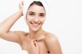 Beauty and Skin care concept - Beautiful caucasian Young Woman with bath towel on head covering her breasts, on white. Royalty Free Stock Photo