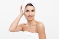 Beauty and Skin care concept - Beautiful caucasian Young Woman with bath towel on head covering her breasts, on white. Royalty Free Stock Photo