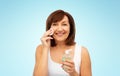 Senior woman cleaning face by lotion on cotton pad Royalty Free Stock Photo