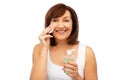 Senior woman cleaning face by lotion on cotton pad Royalty Free Stock Photo