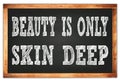 BEAUTY IS ONLY SKIN DEEP words on black wooden frame school blackboard Royalty Free Stock Photo