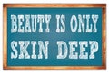 BEAUTY IS ONLY SKIN DEEP words on blue wooden frame school blackboard Royalty Free Stock Photo