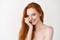 Beauty and skincare. Close-up of happy redhead woman with pale perfect skin, laughing and showing white teeth, standing Royalty Free Stock Photo