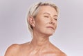 Beauty, skincare and face of a senior woman posing with closed eyes and topless against grey studio background. Happy Royalty Free Stock Photo