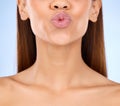 Beauty, skincare and lips kiss with a model pout with lip gloss makeup in studio. Cosmetic, mouth and healthy natural