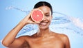 Beauty, skincare and water splash with black woman and grapefruit over eye for vitamin c, luxury and spa. Shower